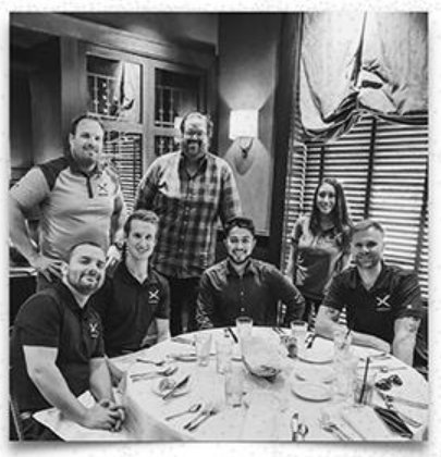 The early window-franchise crew around a dinner table